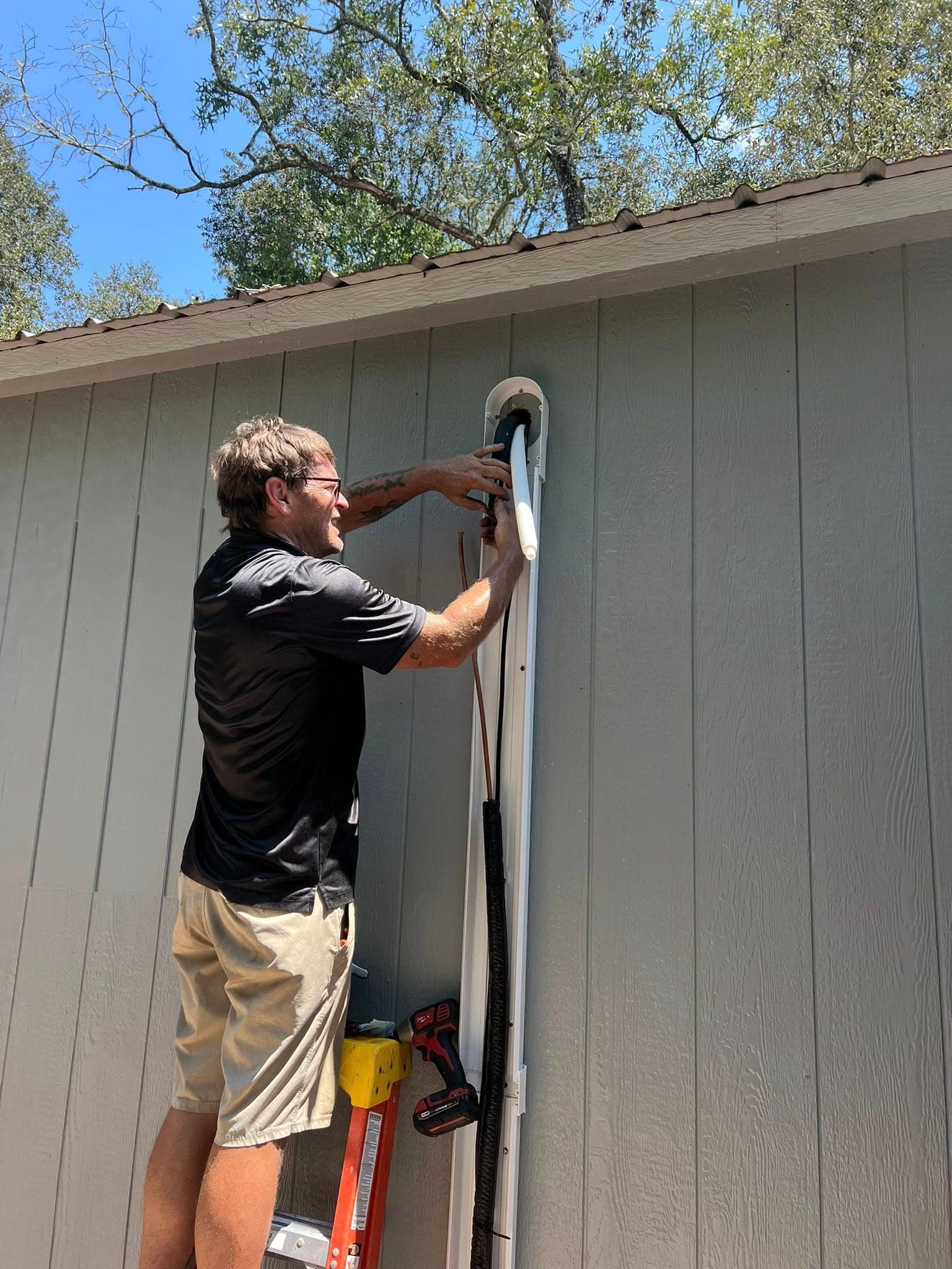 A/C line set installation on exterior wall by Southern Solutions technician in Gainesville, FL